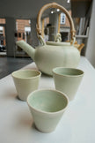 Tiny glossy light green cups