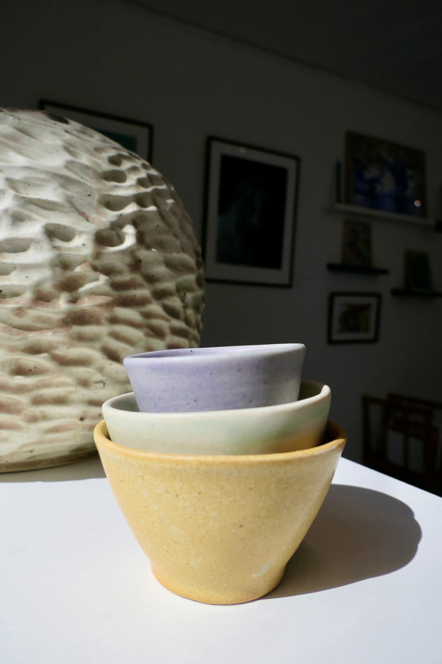 Tiny glossy light green cups