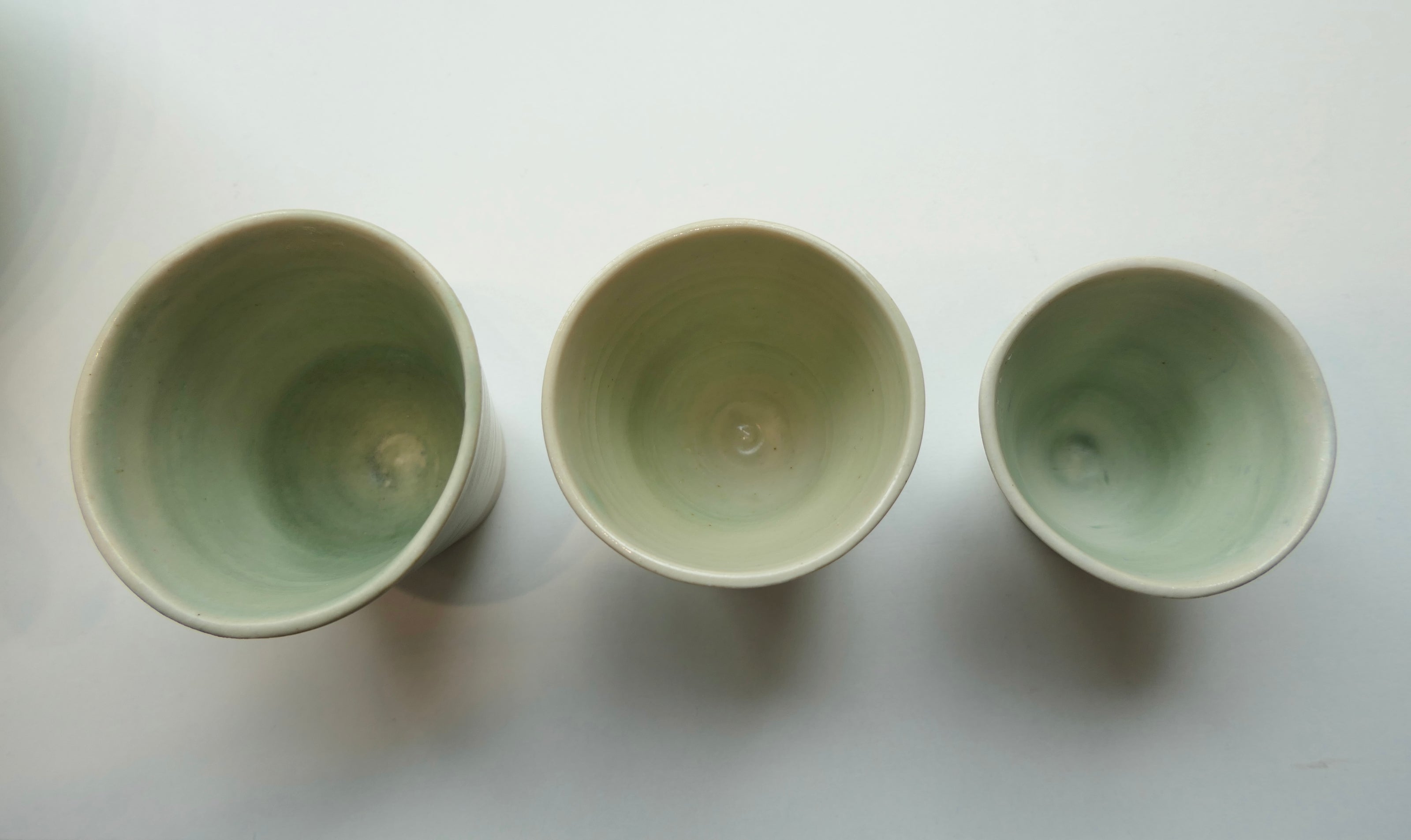 Tiny glossy light green cups