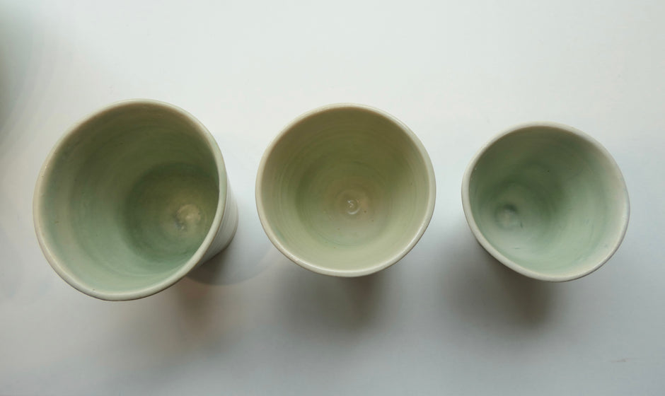 Tiny glossy light green cups